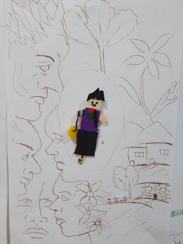 A small crafted image of a person surrounded by drawings of trees, faces and buildings
